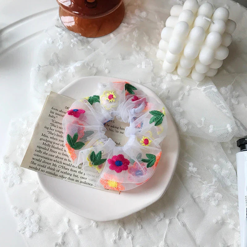 Handmade floral elastic hair bands with soft chiffon fabric and vibrant embroidered daisy patterns, perfect for enhancing everyday style in the UK.