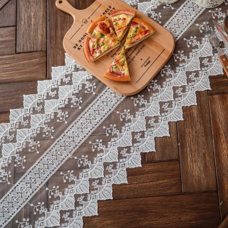 Elegant lace table runner with intricate embroidery and hollowed-out patterns, adding sophistication to any dining setting