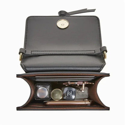 Stylish black leather crossbody phone bag with tassel accent, offering secure storage and versatile design for everyday use.