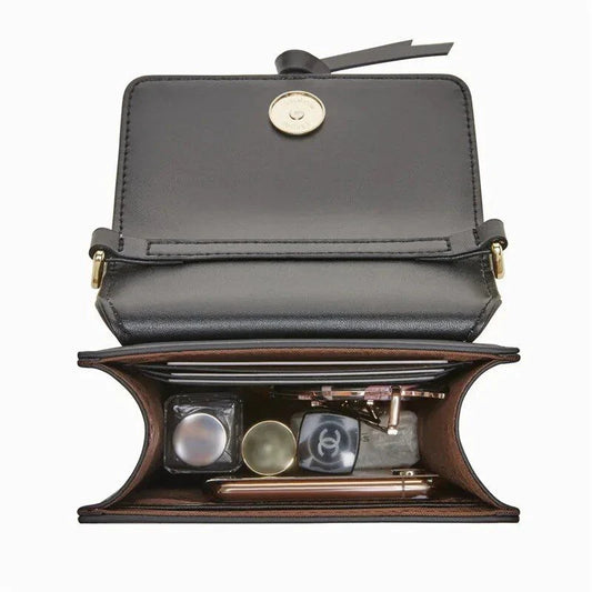 Stylish black leather crossbody phone bag with tassel accent, offering secure storage and versatile design for everyday use.