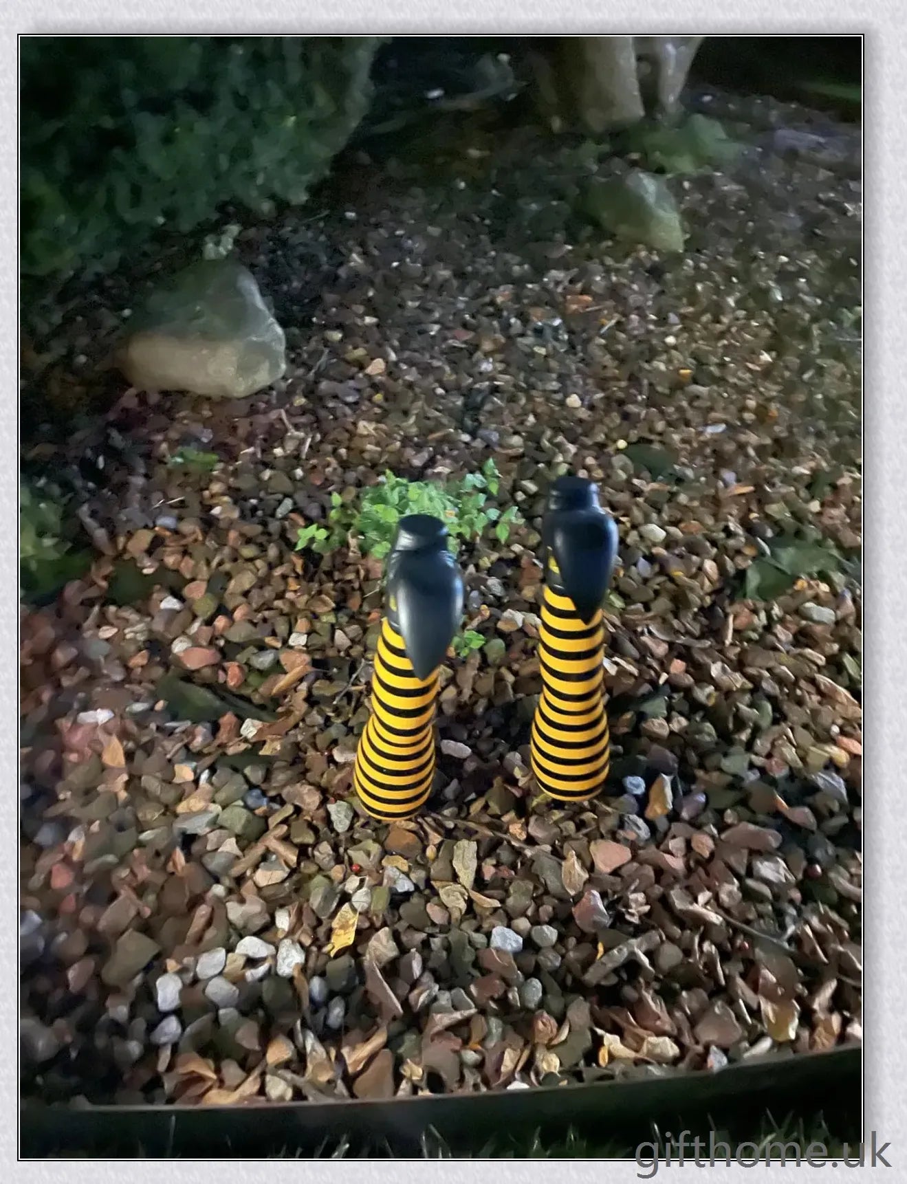 Animated witch legs in various colours, including purple, yellow, and black and white, kicking and moving to create a spooky Halloween display