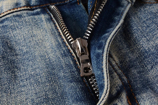 Stylish distressed denim jeans with a skinny, knee-exposed silhouette for a contemporary, high-street fashion look