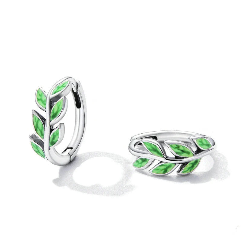 Elegant silver earrings with a fern-inspired design and sparkling green zircon centerpiece