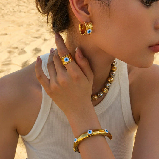 Luxury 18K gold-plated earrings with a unique Devil's Eye design and hammer grain texture in stainless steel