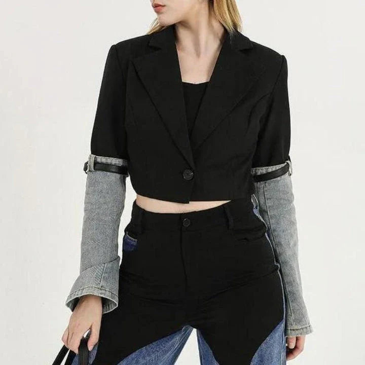 A stylish denim patchwork blazer with a notched collar and single-button closure, designed for the modern British woman