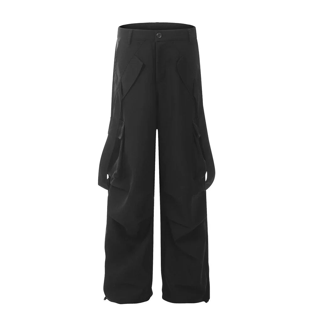 Stylish black pleated overalls with ribbon pockets, a versatile and refined menswear piece.