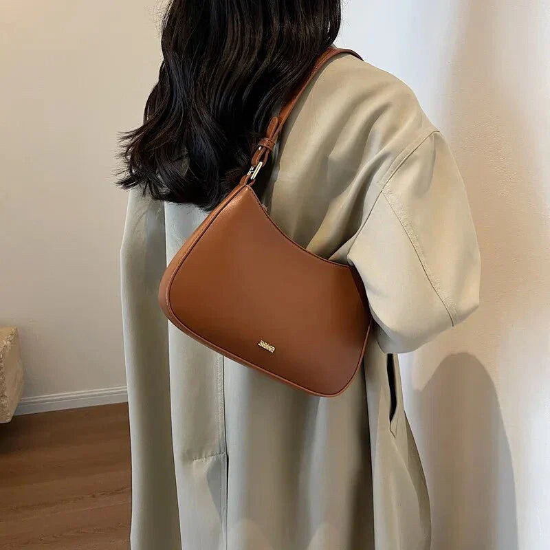 Luxury red leather crossbody bag with sleek design and elegant details