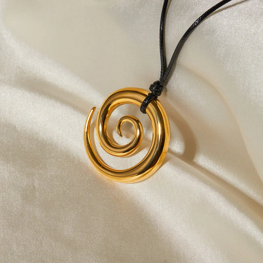 Exquisite spiral circle pendant necklace with 18K gold plating and black rope chain, a versatile accessory for the modern British woman.