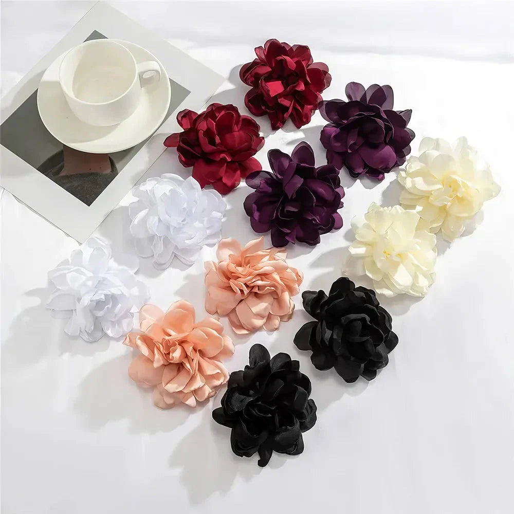 Exquisite fluffy fabric flower stud earrings in a black metal colour, featuring oversized fabric blooms for a unique and elegant design.