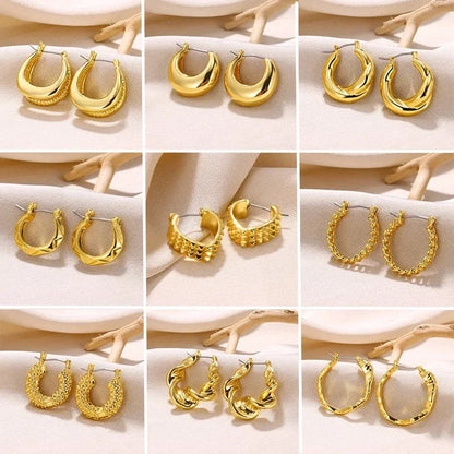 A pair of gold-toned stainless steel hoop earrings, showcasing a classic and sophisticated design