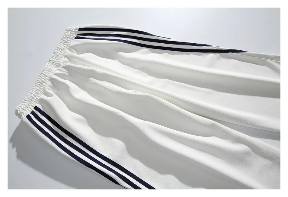 Stylish striped sports trousers in a relaxed, mid-waist design for versatile leisure and athletic wear