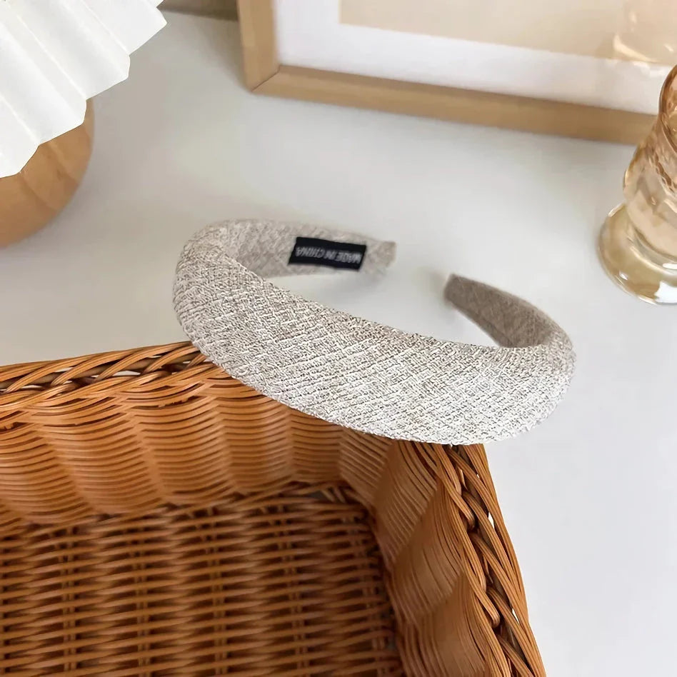 A stylish wide hairband in a classic plaid pattern, offering a chic and sophisticated look for British women.