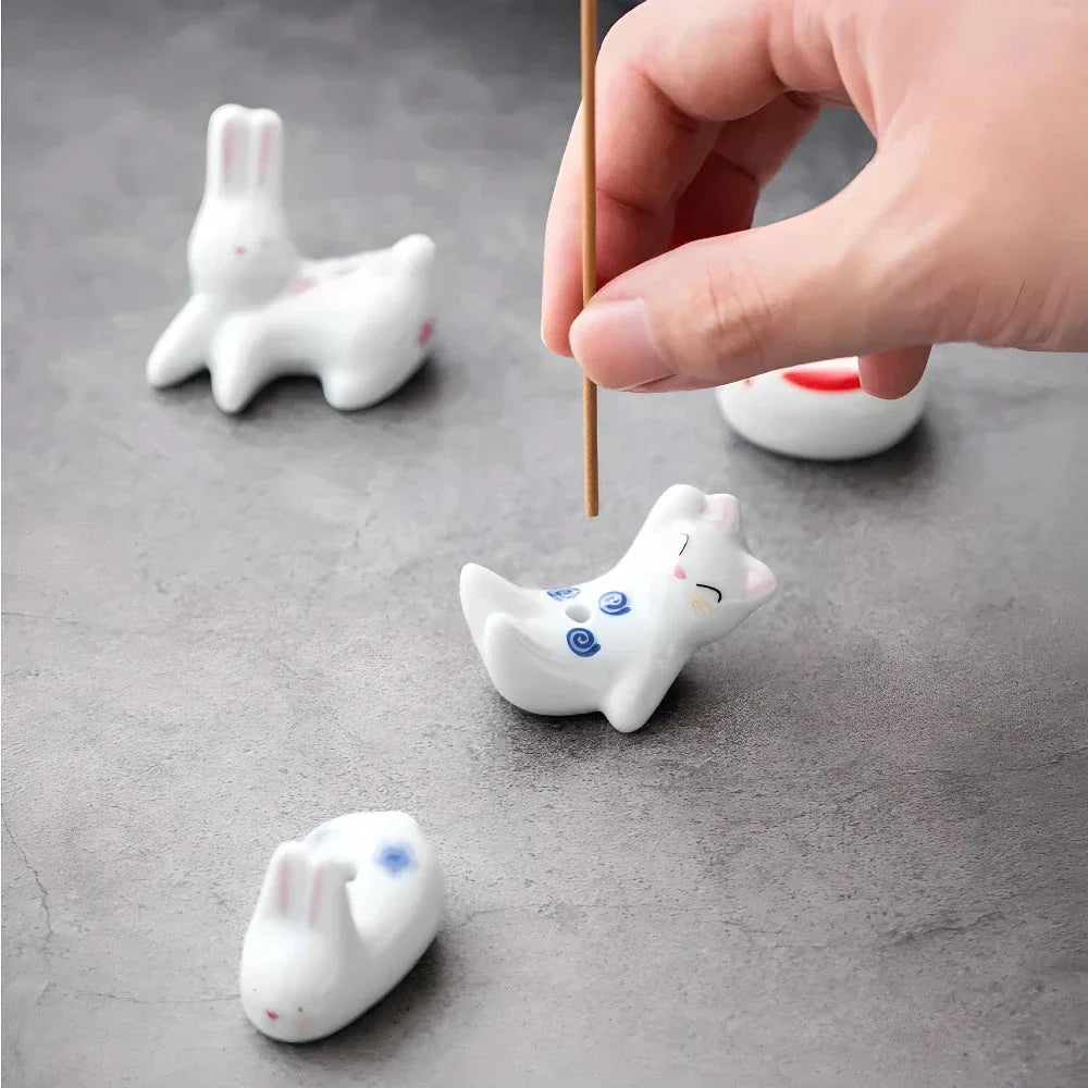 Charming Japanese-style ceramic incense holder with a playful rabbit and kitten design, perfect for creating a relaxing atmosphere in any room.