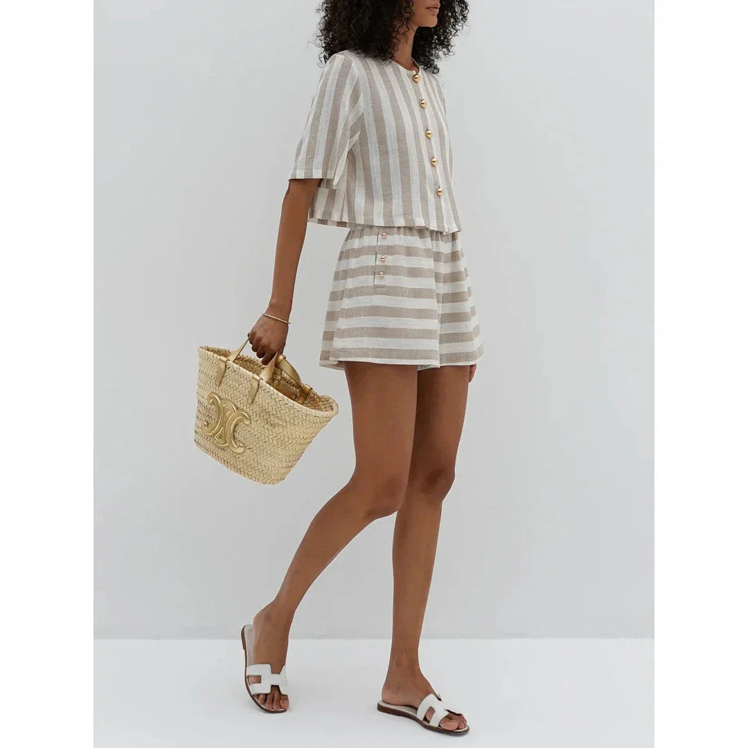 Relaxed and stylish two-piece summer outfit with a striped pattern, featuring a short-sleeved shirt and high-waist shorts.