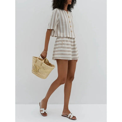 Relaxed and stylish two-piece summer outfit with a striped pattern, featuring a short-sleeved shirt and high-waist shorts.