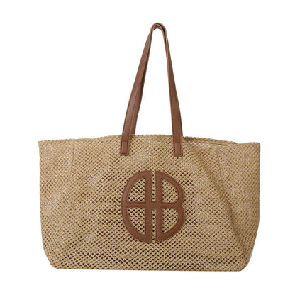 A handmade straw tote bag with a unique hollow-out knitting design, featuring a soft faux fur lining and a spacious interior for versatile use.