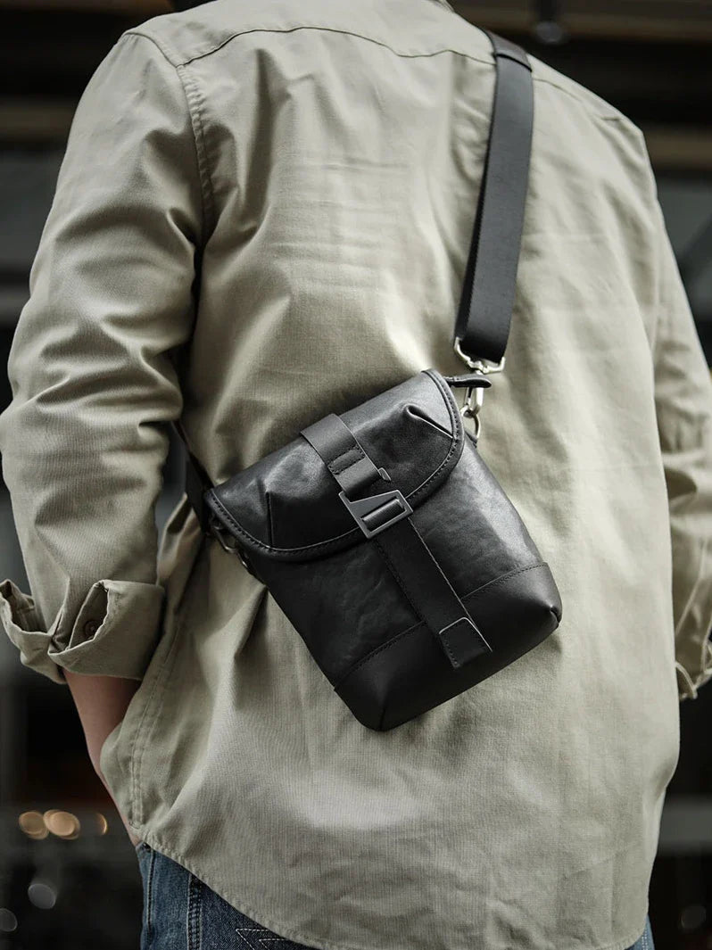 Premium cowhide leather shoulder sling bag with one-shoulder design and oblique paneling for modern British style