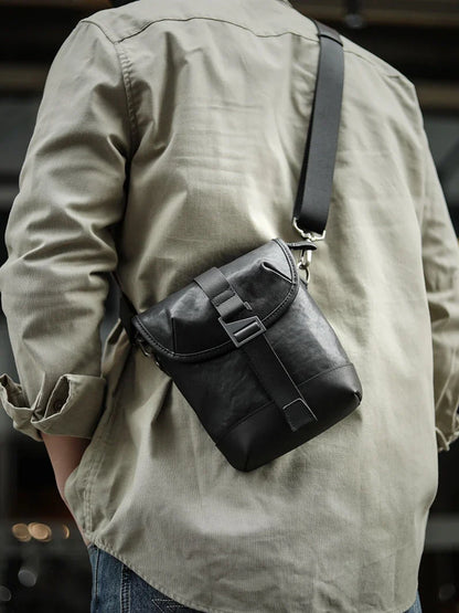 Premium cowhide leather shoulder sling bag with one-shoulder design and oblique paneling for modern British style