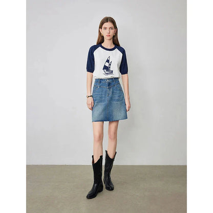 Sophisticated lyocell denim mini skirt with classic A-line silhouette and functional pockets for the discerning British woman