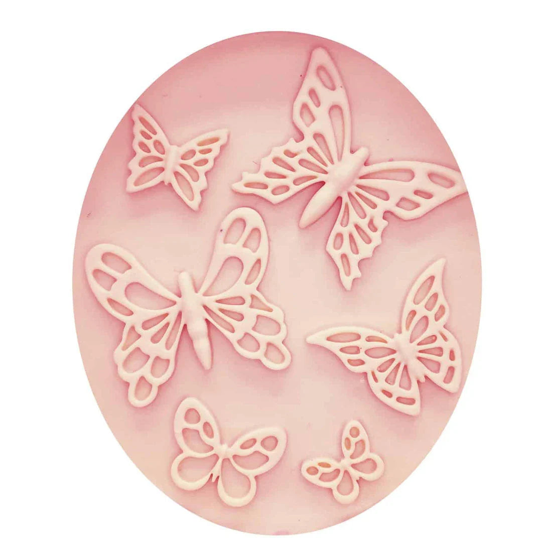 A pink butterfly-shaped silicone fondant mould for creating detailed and intricate fondant decorations