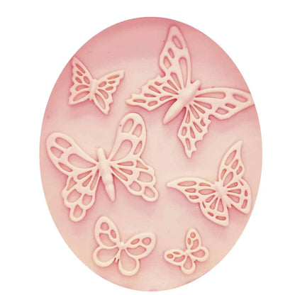 A pink butterfly-shaped silicone fondant mould for creating detailed and intricate fondant decorations