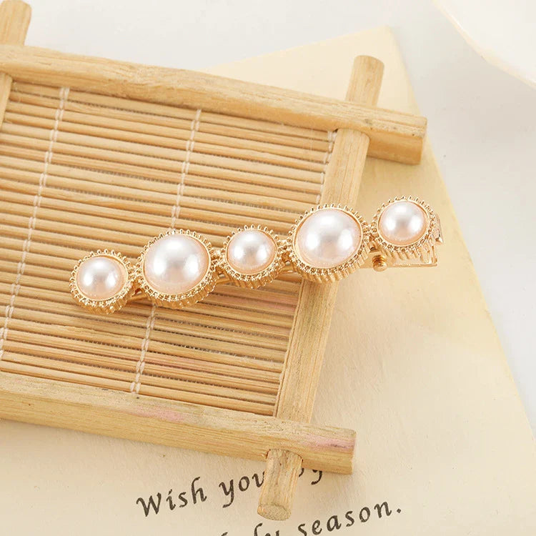 Elegant silver-toned hair clip with a beautiful pearl flower design, a timeless British-inspired accessory