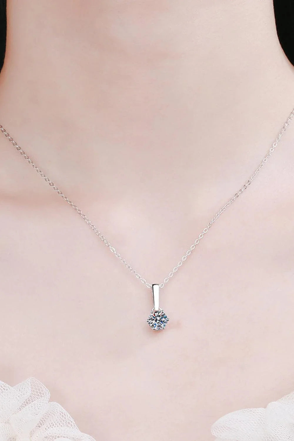 Elegant 1 carat moissanite and sterling silver necklace with a polished, modern design