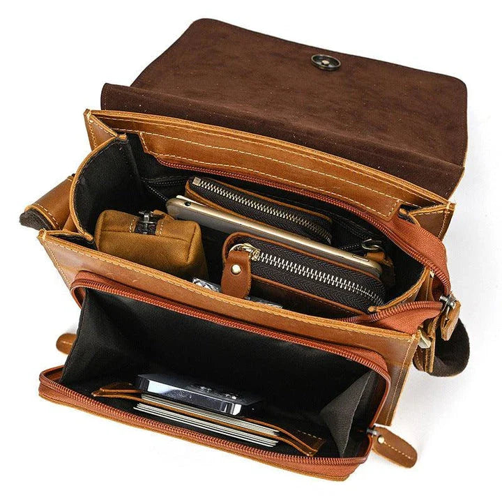 Premium leather crossbody bag with flap closure, vertical square shape, and multiple interior compartments