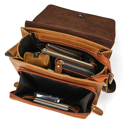 Premium leather crossbody bag with flap closure, vertical square shape, and multiple interior compartments