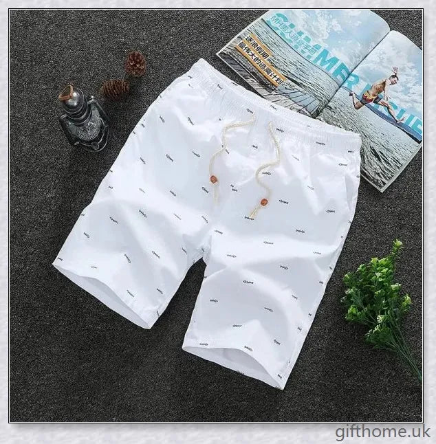 Pair of premium cotton beach shorts in navy blue, khaki, and slate grey colours, perfect for stylish seaside adventures