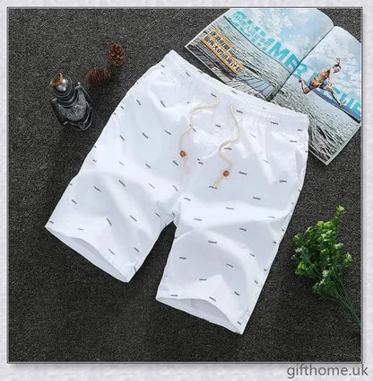 Pair of premium cotton beach shorts in navy blue, khaki, and slate grey colours, perfect for stylish seaside adventures
