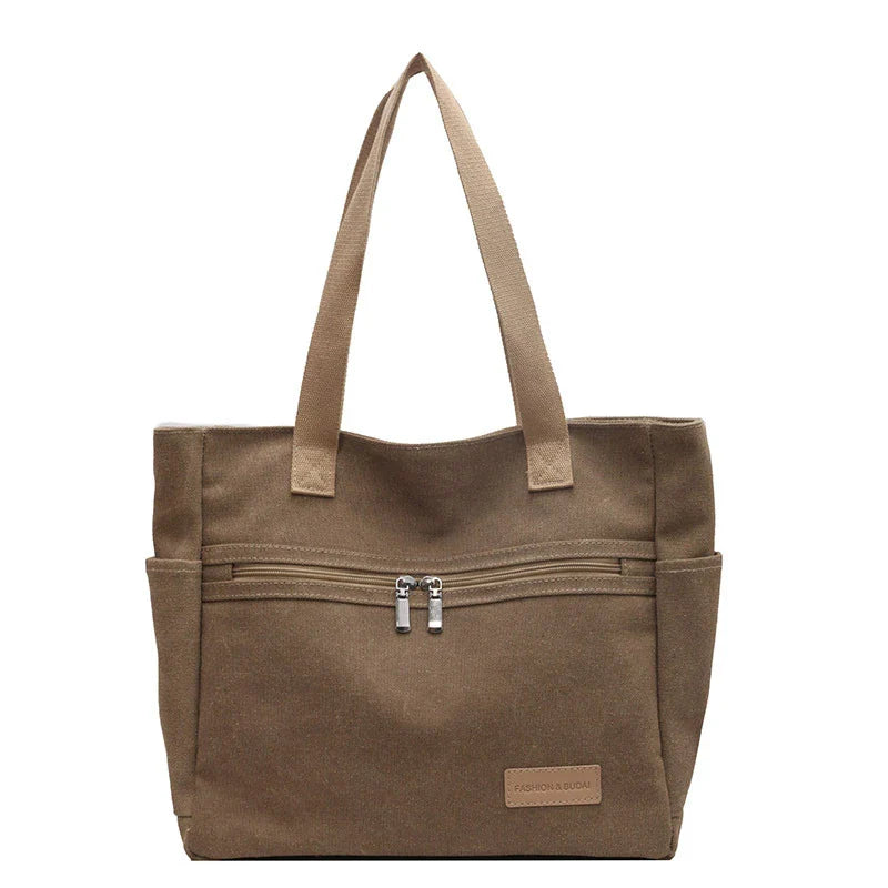 Premium canvas shoulder bag in grey, khaki, and green colours, featuring a stylish and functional design for everyday use.