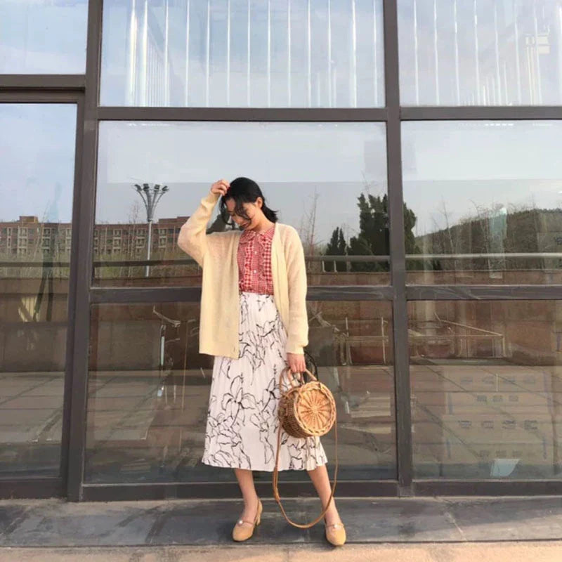 Elegant handcrafted rattan basket handbag with floral design, showcasing traditional British craftsmanship and modern sophistication