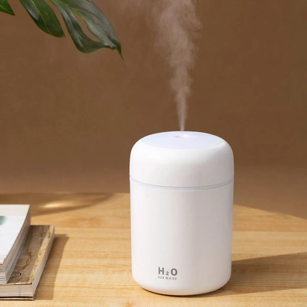Compact in-car LED humidifier with rainbow mood lighting, designed to freshen and relax your vehicle's interior