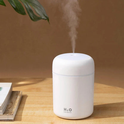 Compact in-car LED humidifier with rainbow mood lighting, designed to freshen and relax your vehicle's interior