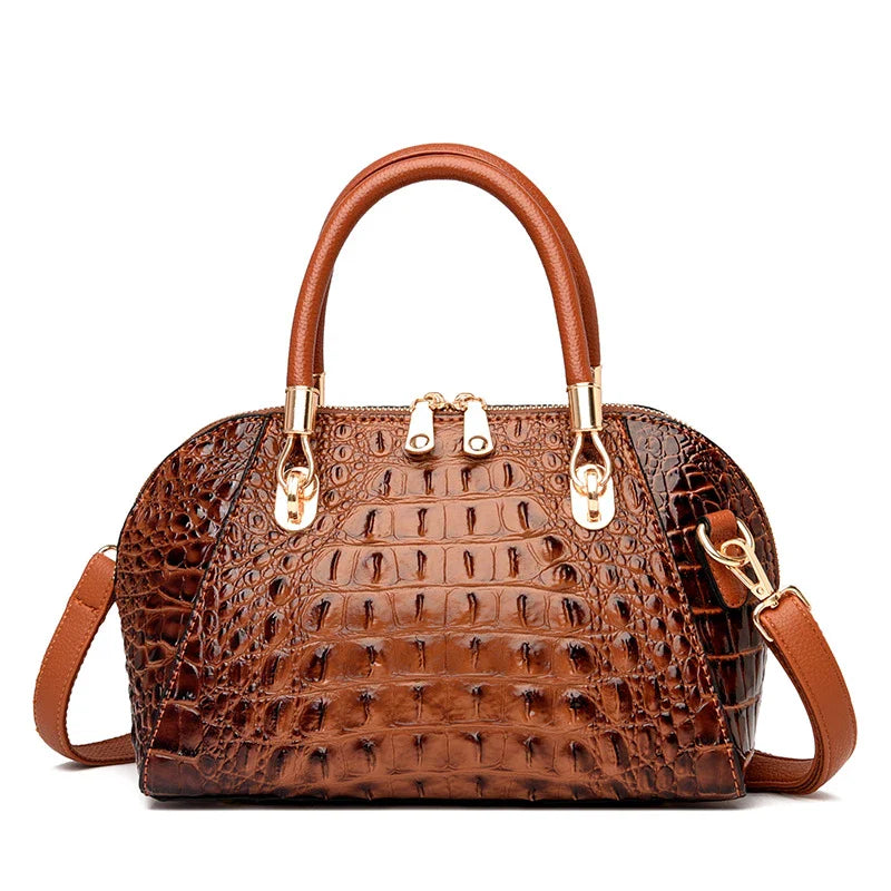 Premium leather one-shoulder messenger bag in various colours, featuring a sleek, shell-inspired silhouette and multiple internal pockets for organisation.