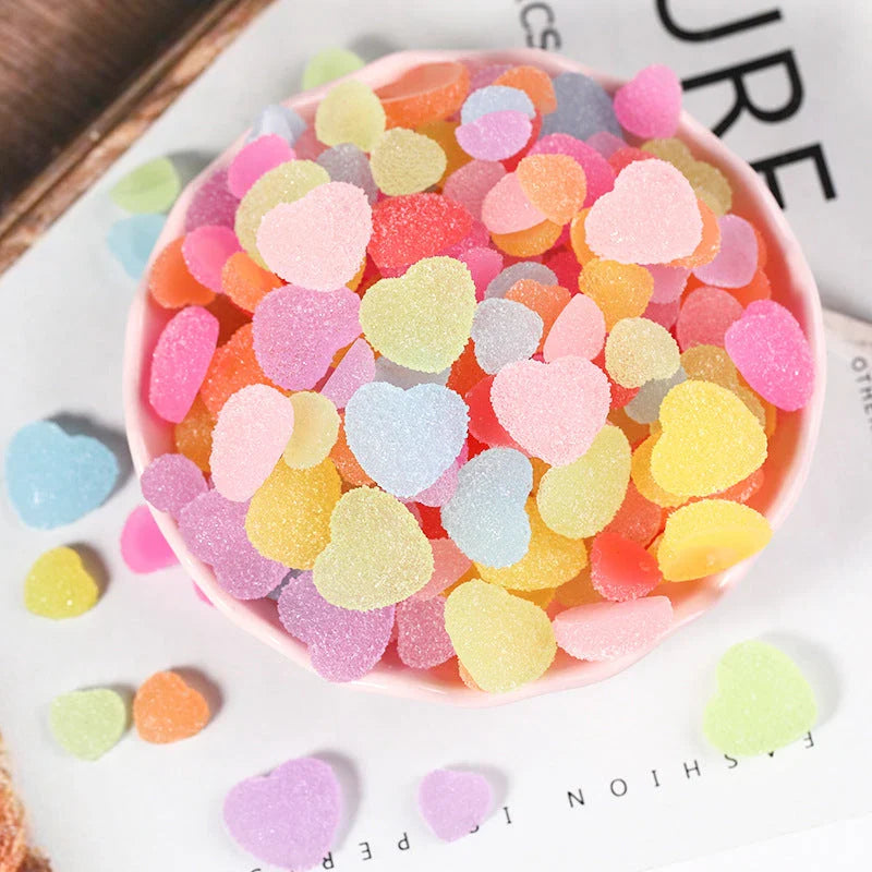 Heart and star-shaped nail charms with candy-inspired designs for creating unique and eye-catching nail art