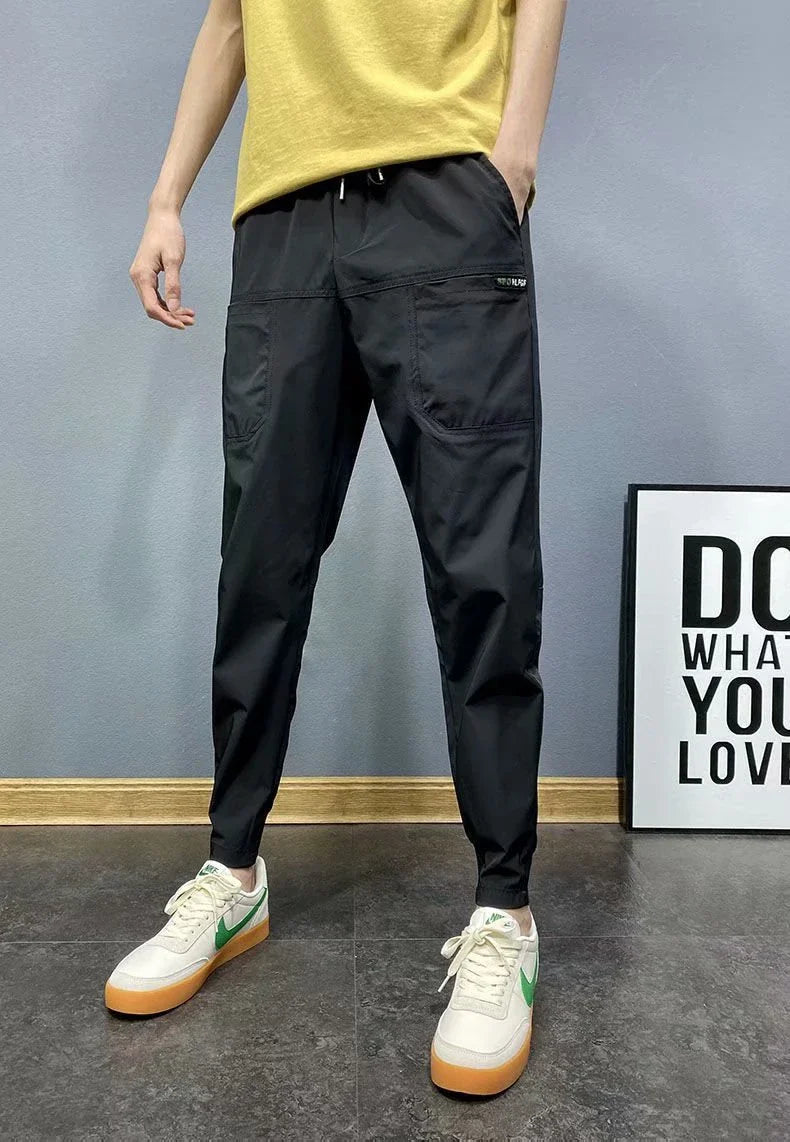 Premium slim-fit drawstring joggers in black and grey, featuring a tailored silhouette and adjustable waistband for a polished, comfortable look.
