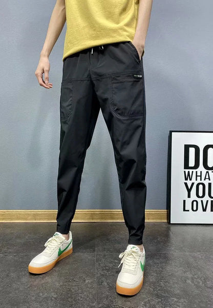Premium slim-fit drawstring joggers in black and grey, featuring a tailored silhouette and adjustable waistband for a polished, comfortable look.