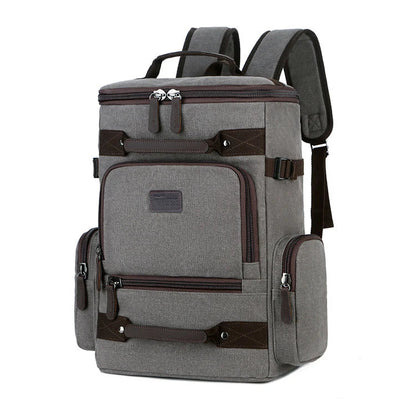 A classic messenger bag made of durable canvas with genuine leather trim, offering style and function for the modern British gentleman