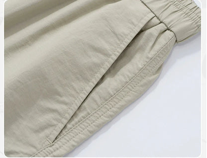 Premium men's quick-drying casual trousers in black, caramel, and sand colours with a relaxed, loose fit