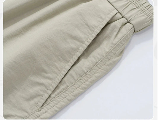Premium men's quick-drying casual trousers in black, caramel, and sand colours with a relaxed, loose fit