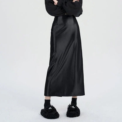 Luxurious silver satin maxi skirt with high-waist design and chic back split for elegant and versatile style.