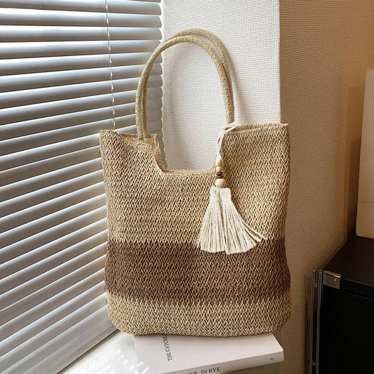 Stylish bohemian-inspired woven tote bag with contrasting tassels, perfect for summer outings