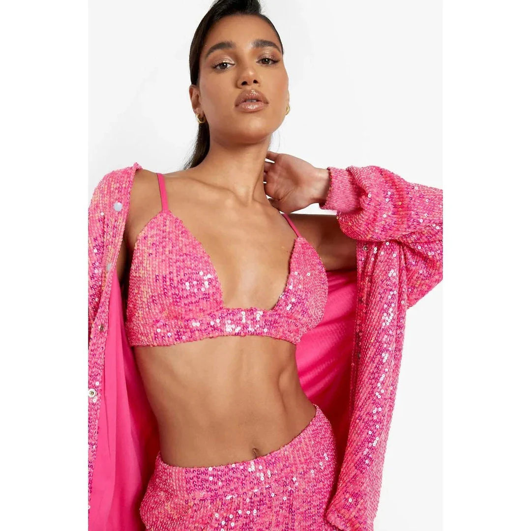 Elegant woman wearing a luxurious sequin top and pants set, perfect for a glamorous evening event
