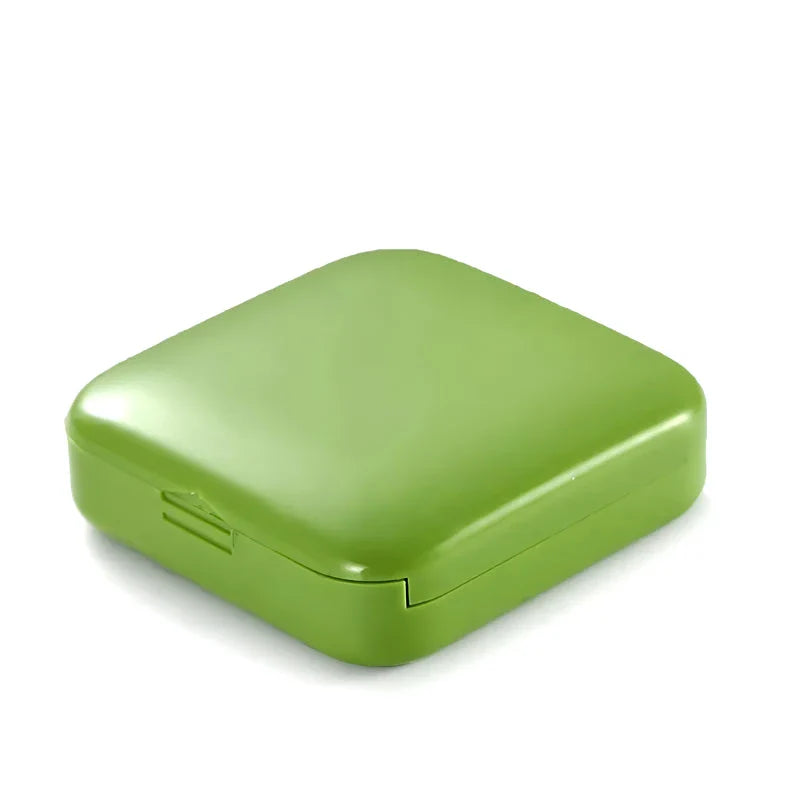 Compact push-pull pill case organiser in various vibrant cartoon-inspired colours for convenient medication management