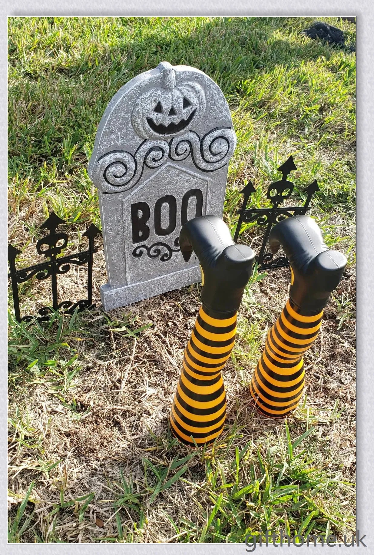 Animated witch legs in various colours, including purple, yellow, and black and white, kicking and moving to create a spooky Halloween display
