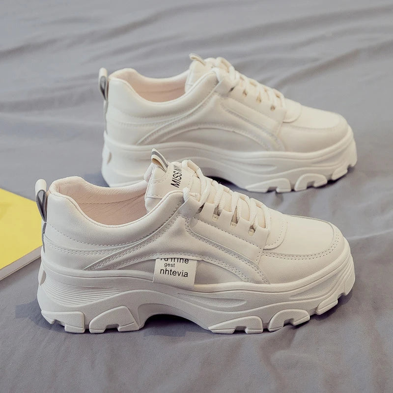 Fashionable women's casual trainers in beige and white colours, featuring a sporty yet chic design for everyday wear.