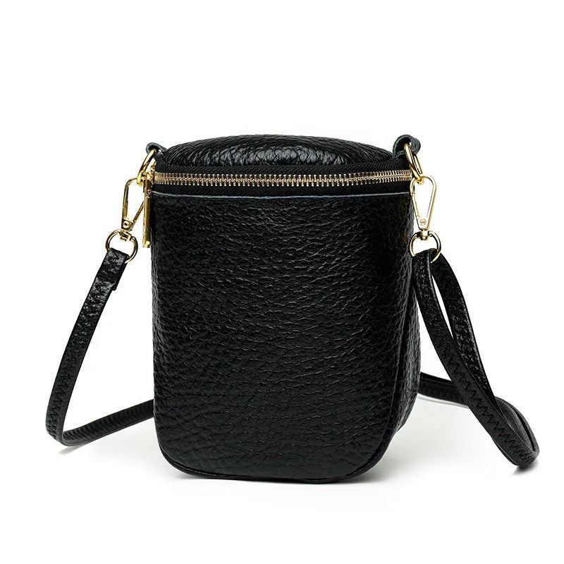 Elegant leather crossbody bag with adjustable strap, multiple pockets, and premium cowhide construction for the modern British woman