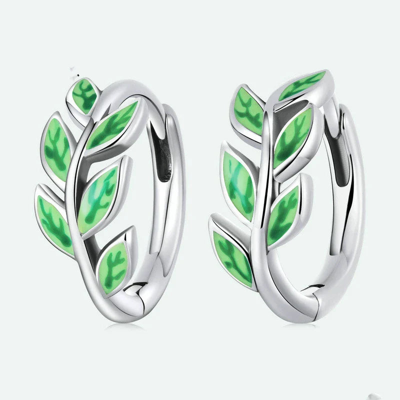 Elegant silver earrings with a fern-inspired design and sparkling green zircon centerpiece